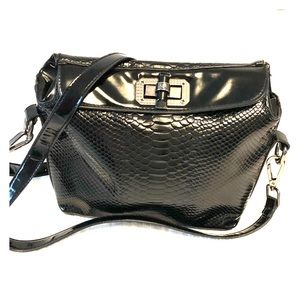 Crossbody black patent snake skin style bag.
